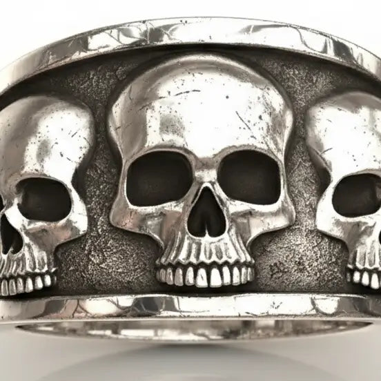 Gros plan sur la Bague Fraternité des Ombres montrant les crânes ciselés en relief sur métal.