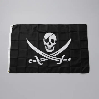 Drapeau pirate Jolly Roger noir avec crâne et épées croisées.