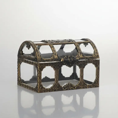 Mini-coffre transparent finition bronze, structure ajourée sur fond neutre.