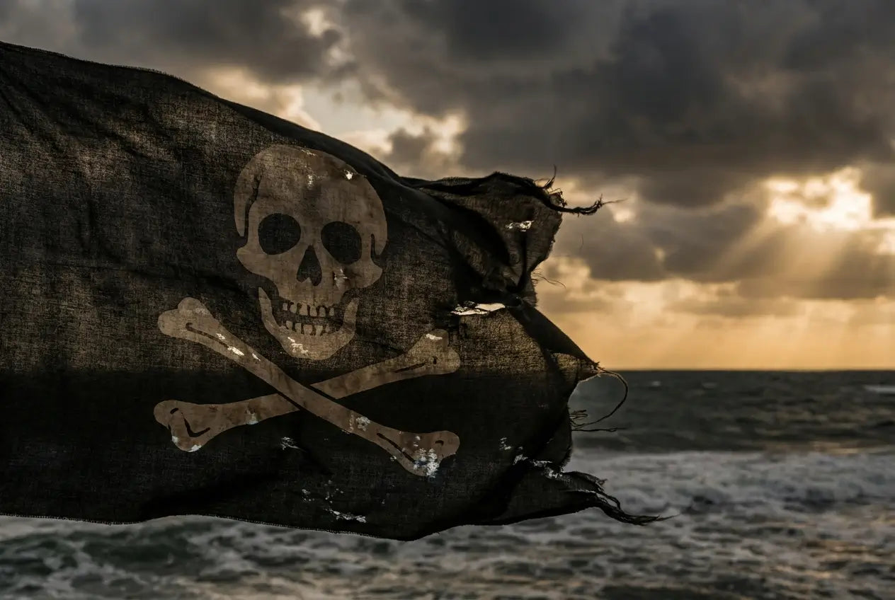 Pavillon noir Jolly Roger avec crâne et os croisés, qui flotte au vent, incarnant le symbole des pirates et de la liberté.