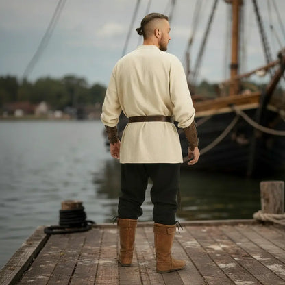 Vue arrière de la tenue complète du flibustier portée sur un ponton en bord de mer.
